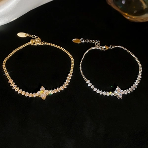 Close-up of sparkling flower bracelets with marquise zircon stones in gold and silver