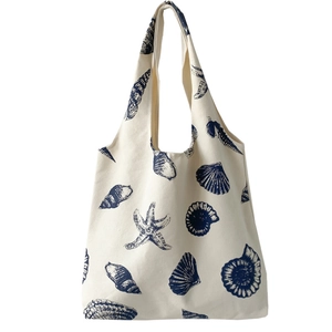 Cute canvas tote bag with navy blue seashell and starfish patterns on cream fabric