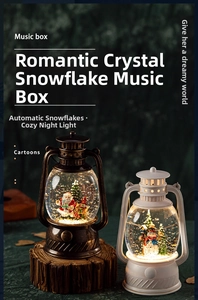 Close-up of vintage Christmas lantern music boxes with snow globe and Santa scenery
