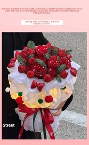 Detail of Christmas strawberry rose bouquet with warm LED lights and red ribbons