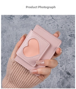 Handheld view of a pink litchi texture card holder featuring a heart-shaped window