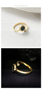 Detailed macro view of gold Roman numeral ring with black inlay and small zircon stone