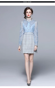 Detailed close-up of light blue lace top with pearl collar and tweed dress texture