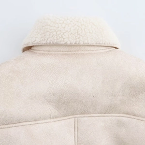 Close-up detail of shearling collar and suede texture on chic beige autumn jacket