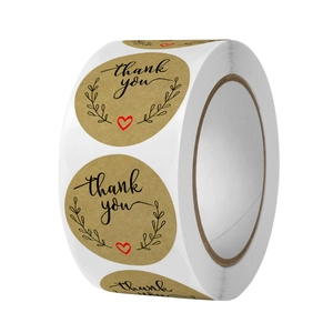 Roll of round kraft paper thank you stickers with black floral text and a small red heart