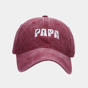 Detailed view of PAPA embroidery with fishing motifs on washed cotton baseball cap