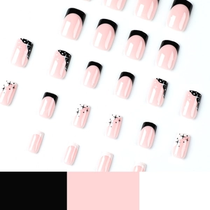 Pink and black French press-on nails with white star and dot artistic hand-painted patterns