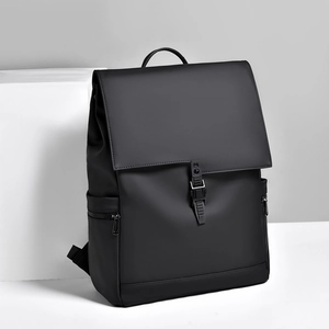 Minimalist black waterproof business backpack with buckle closure on geometric stand