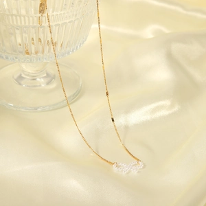Elegant 18k gold plated stainless steel necklace featuring a white pearl bow pendant