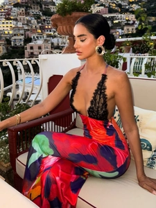 Close-up of intricate black lace trim on a vibrant marble print summer maxi dress
