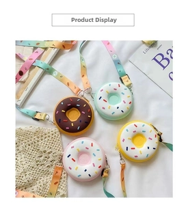 Flat lay view of four colorful donut silicone crossbody bags with rainbow straps