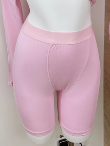 Detail of pink knitted slimming shorts showing elastic texture and body-hugging fit
