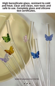 Detail of colorful butterfly glass straws with smooth borosilicate texture and 3D accents