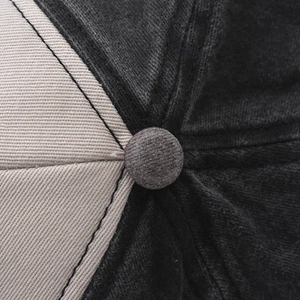 Macro shot of baseball cap crown showing gray corduroy and beige twill fabric textures
