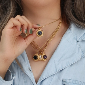 Gros plan de colliers à chaîne torsadée dorée 18K avec pendentifs en agate de couleur