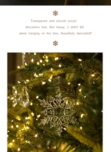 Macro shot of clear acrylic snowflake ornaments hanging on a Christmas tree with warm lights