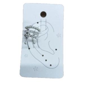 Elegant bow-shaped ear cuff featuring white pearls and silver wire weaving on a display card
