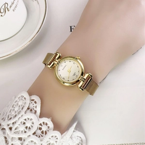 Vintage gold women's quartz watch with metal mesh band and crystal markers on dial