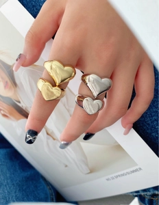 Fashionable double heart rings in gold and silver finish worn by a model