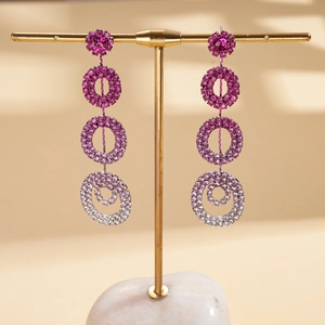 Pink gradient multi-layer geometric hoop earrings with crystals on a golden display stand