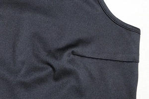 Detail of double-stitched hem on high-density black knit fabric of this fashion crop top