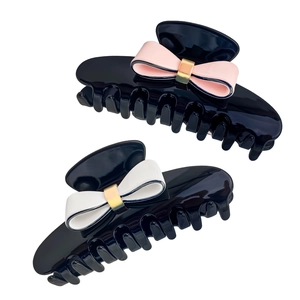 Elegant bow hair claws in black acetate with pink and white accents for French style