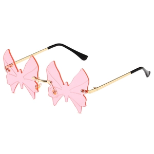 Pink butterfly rimless sunglasses with gold metal temples in a stylish Y2K fashion design