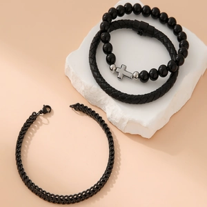 Three-piece set of black beaded, braided leather, and chain bracelets with silver cross charm