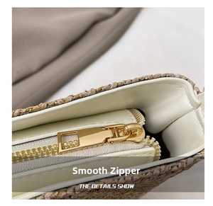 Detailed close-up of smooth gold metal zipper and woven texture on a bucket straw bag
