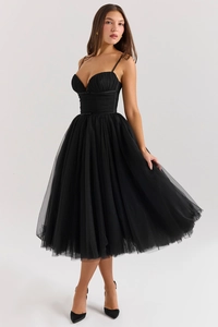 Detail view of black mesh formal dress featuring thin straps and pleated sweetheart neckline