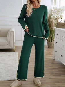 Deep green knit lounge set featuring long-sleeve top and wide-leg pants with beige trim