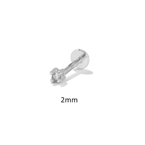 Macro detail of a 2mm silver screw back stud earring with a sparkling 4-prong diamond