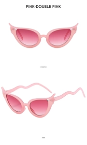 Détail de lunettes de soleil rose œil-de-chat avec branches serpent et monture flamme