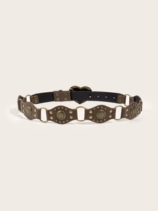 Detail of vintage brown leather belt featuring heart buckle and embossed metal discs