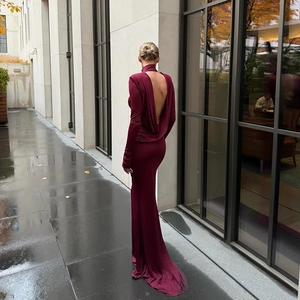 Dettaglio di un elegante abito da sera bordeaux con schiena scoperta e finitura setosa