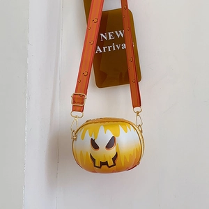 Close-up of Halloween pumpkin smiley crossbody bag with decorative orange strap