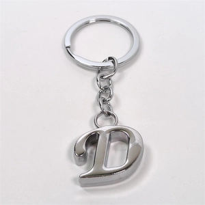 Polished silver metal letter D keychain with ring and short chain on a white background