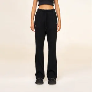 Black flare sports pants with cross embroidery and metal stud details on the side
