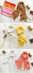 Multiple colors of cashmere-like scarves with tassels and aesthetic lifestyle accessories