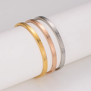 Three-tone stainless steel spiral texture bangles in gold, rose gold, and silver finishes