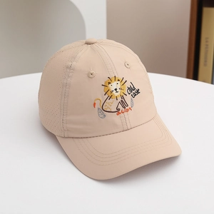 Detail of cartoon lion embroidery and breathable mesh on a beige kids sun hat