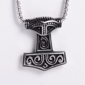 Detail of vintage silver Thor's Hammer pendant with Nordic Viking engraving and chain