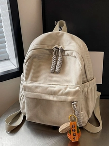 Cream corduroy mini backpack for women featuring a stylish khaki zipper pull and charm