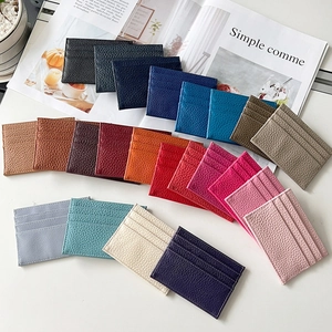 Flat lay of multiple colorful pebble grain leather card holders in various stylish hues