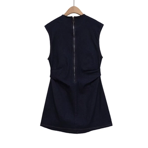Sleeveless round neck denim dress in navy blue with back zipper on a wooden hanger