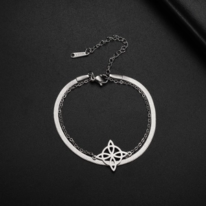 Macro detail of silver stainless steel double layer snake chain and Celtic knot pendant
