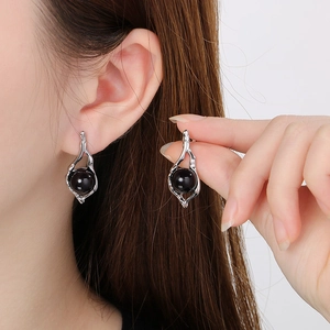 French vintage irregular geometric stainless steel earrings with black pearls on model