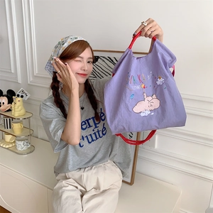 Close-up of purple Zakka elephant tote with red handles and cute cartoon embroidery