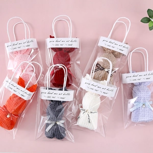 Detail of coral fleece rabbit towels in gift bags with Just For You ribbon accents