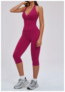 Detail of rose red halter neck sports bra and matching high waist cropped yoga leggings